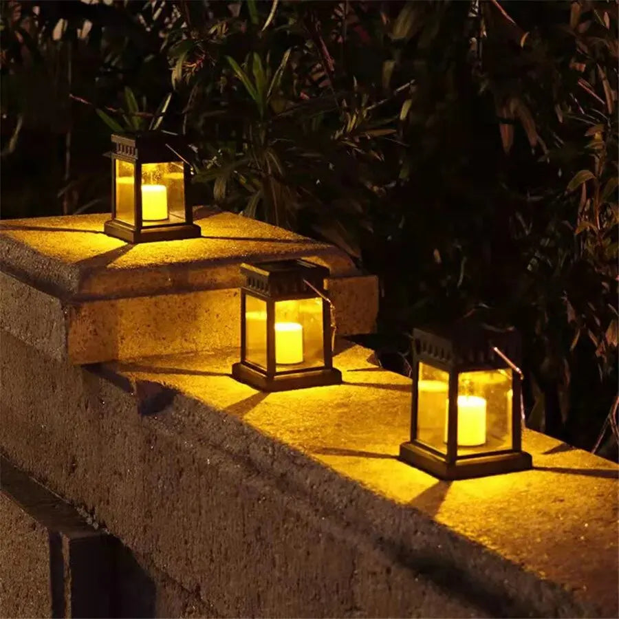 Solar lanterns with LED candle effect placed on an outdoor stone wall