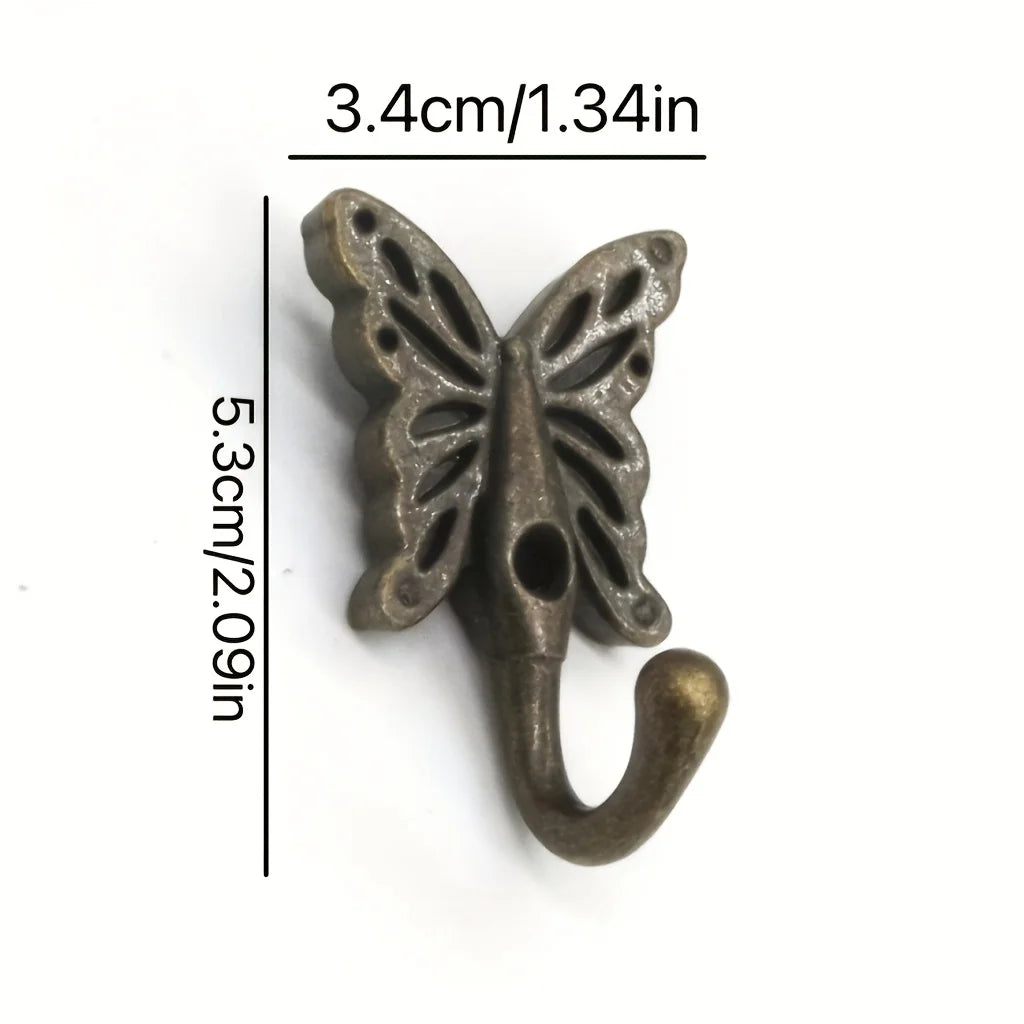 Single butterfly-shaped cast iron wall hook with measurements of 5.3 cm by 3.4 cm