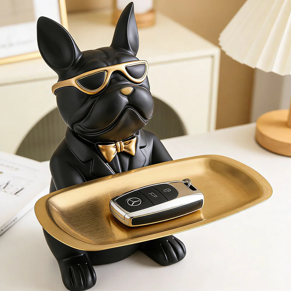 black and gold bulldog catchall statue tray holding car keys on a white entryway table