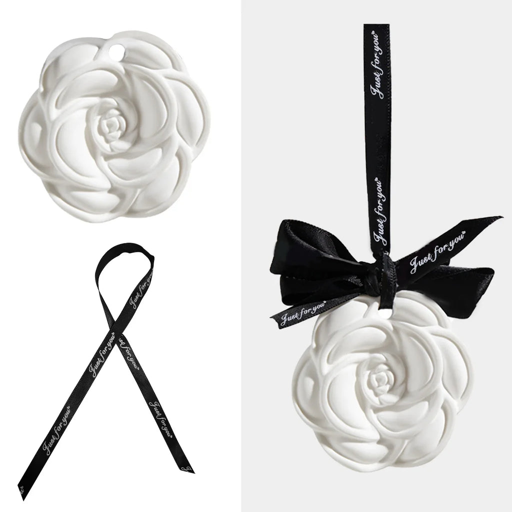 Camellia-shaped ceramic fragrance diffuser pendant with black ribbon