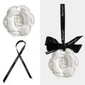 Camellia-shaped ceramic fragrance diffuser pendant with black ribbon