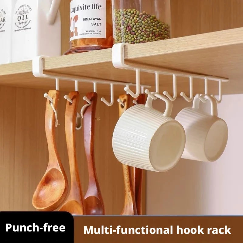 white under-cabinet hanging rack keeping mugs and wooden spoons tidy under a kitchen shelf