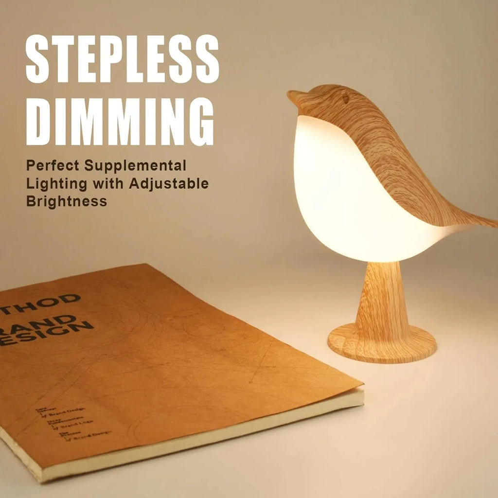 Bird-shaped night light with adjustable dimming on desk beside book