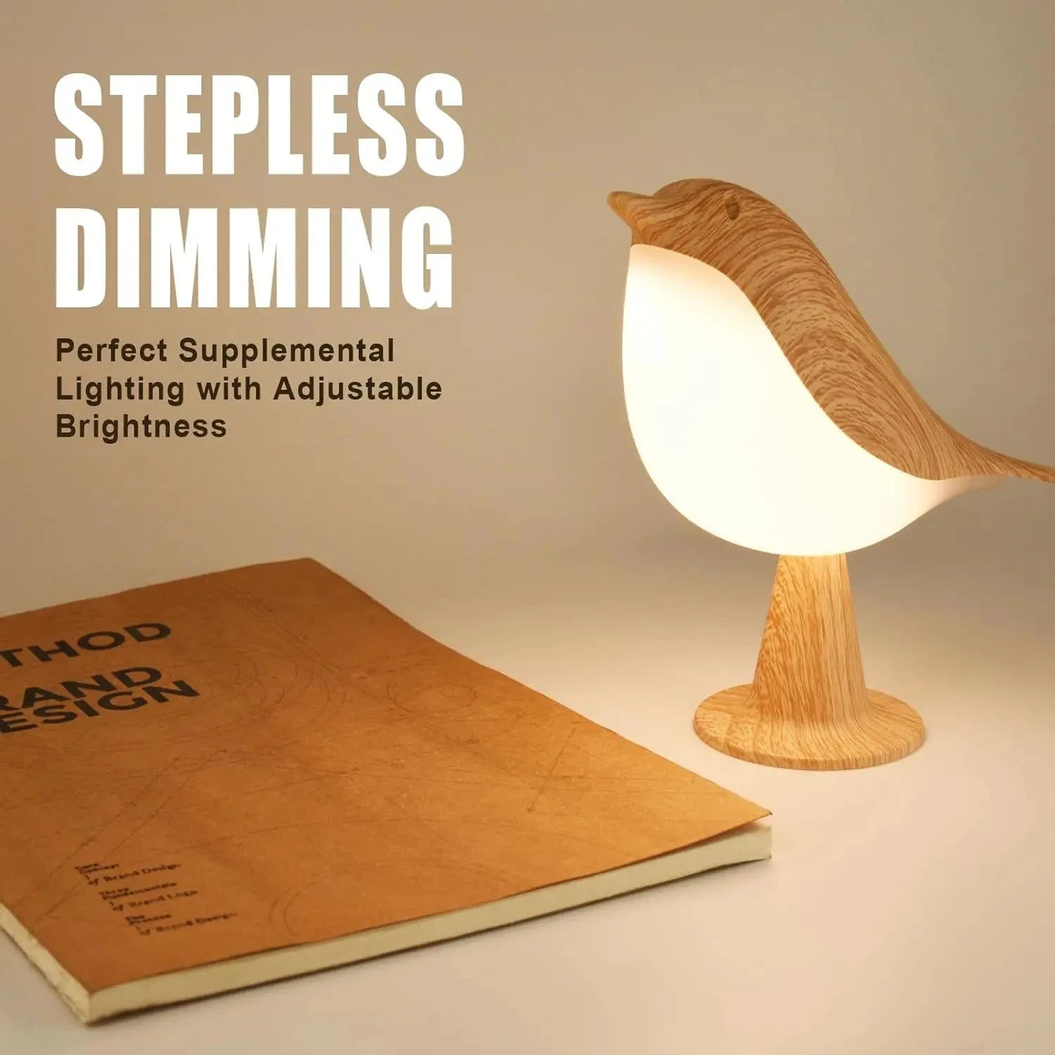 Bird-shaped night light with adjustable dimming on desk beside book