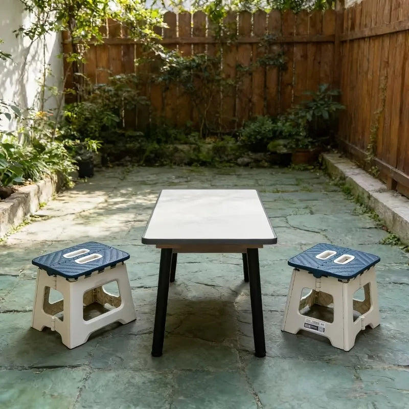 two blue-top folding step stools shown paired with a low table in a garden patio