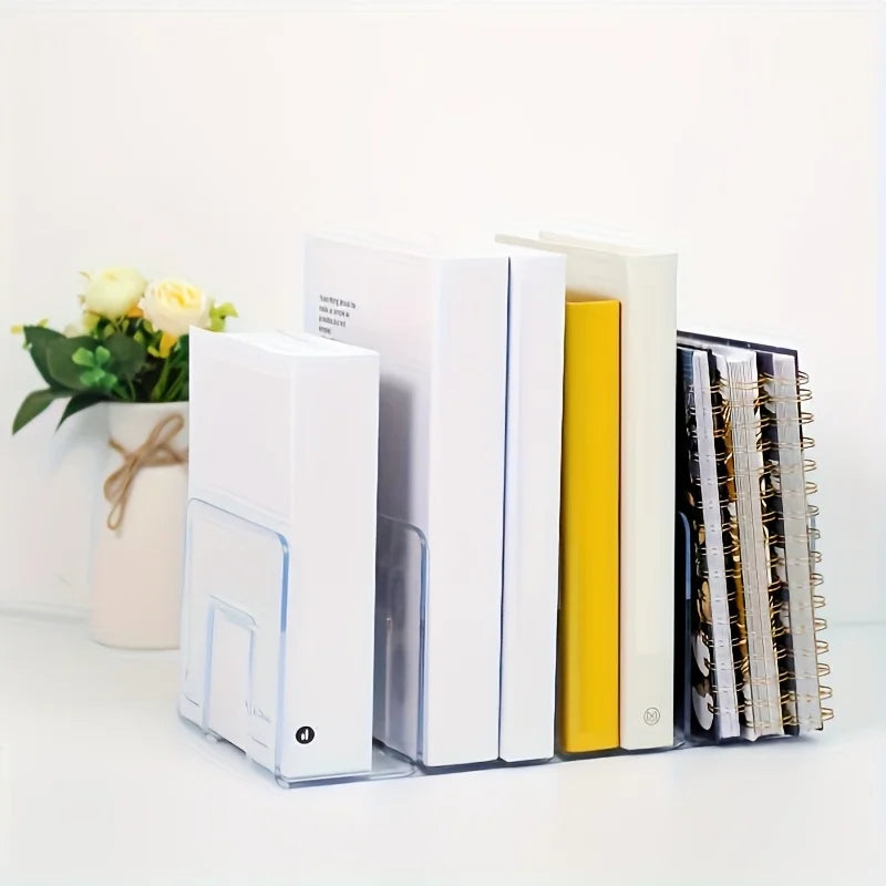 clear acrylic organizer holding upright books and notebooks on a white desk