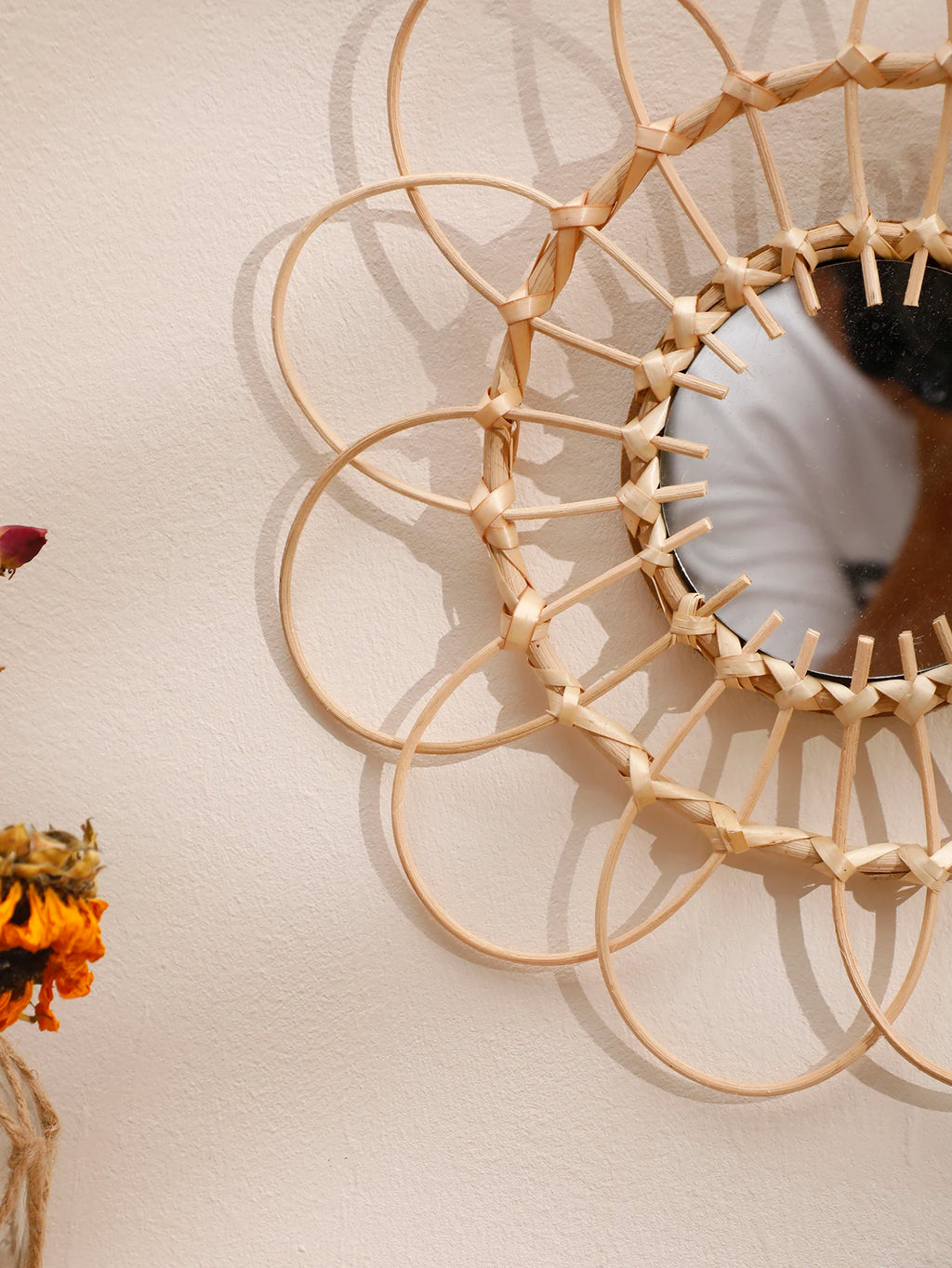Close-up of bamboo rattan loops forming the sunflower shape of the wall mirror