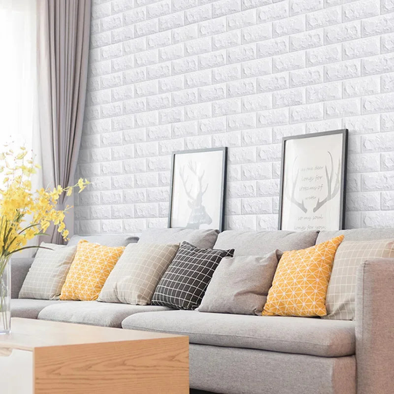 Bright living room with a sofa and framed prints on a wall covered in white 3D brick pattern panels