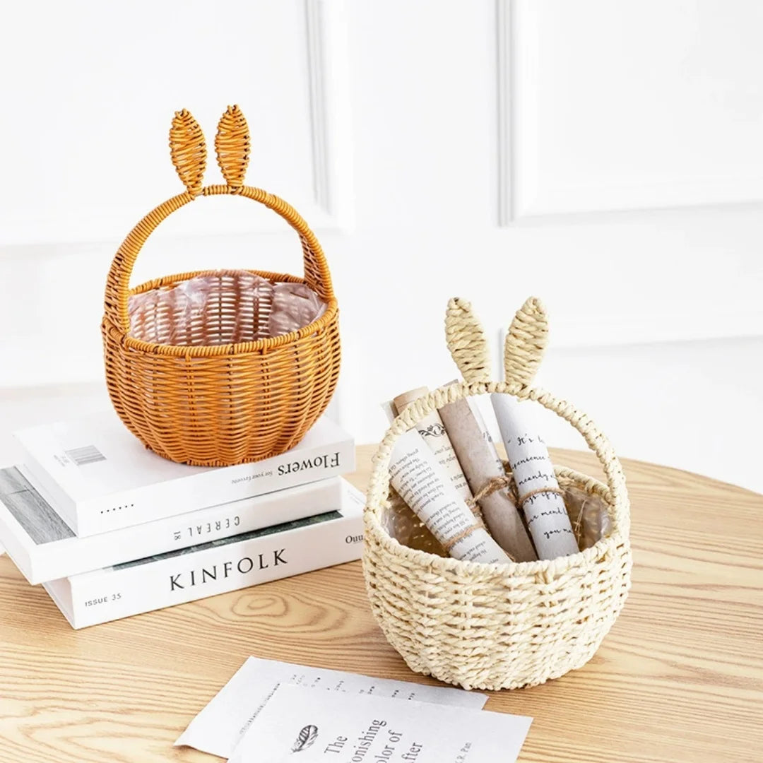 Beige and brown bunny ear baskets used for storing rolled papers, on books