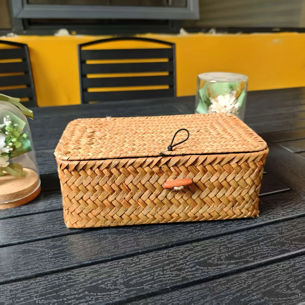Closed lidded bamboo basket with woven texture and toggle closure on a dark table