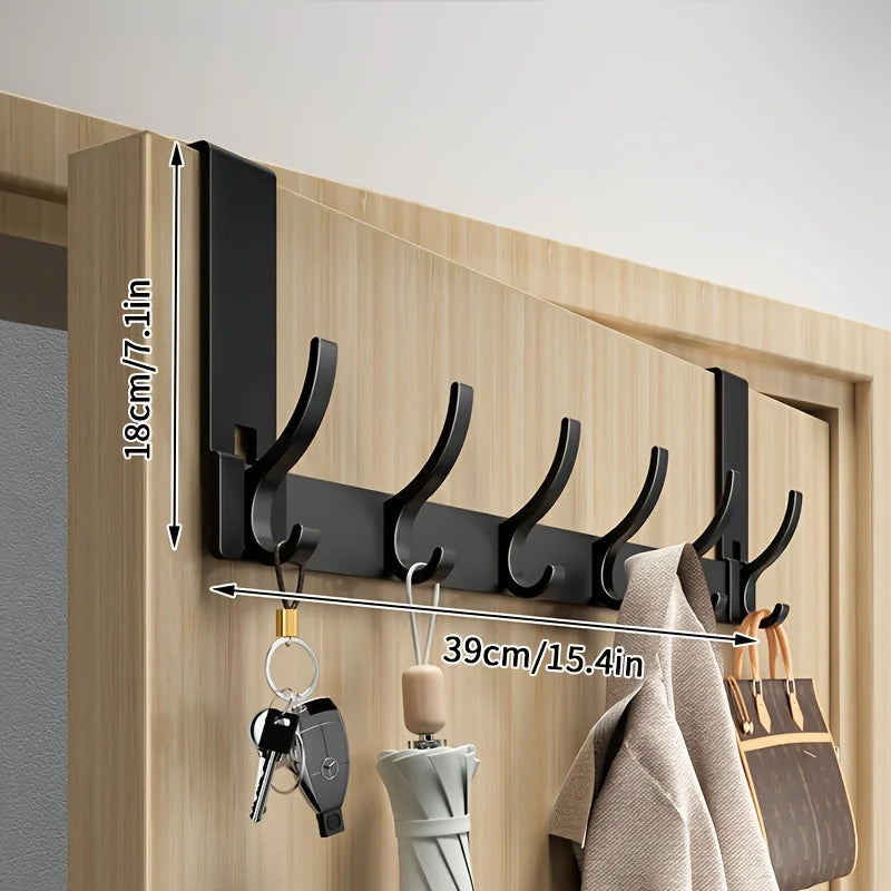 black metal over-the-door hook rack with keys, umbrella, and coat on a wooden door, labeled with height 18cm and width 39cm