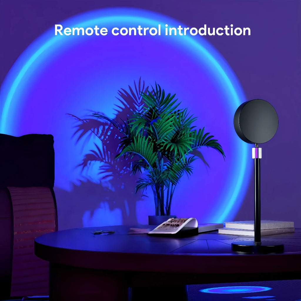 Sunset projection lamp casting blue light on a wall with a plant and books, remote on table
