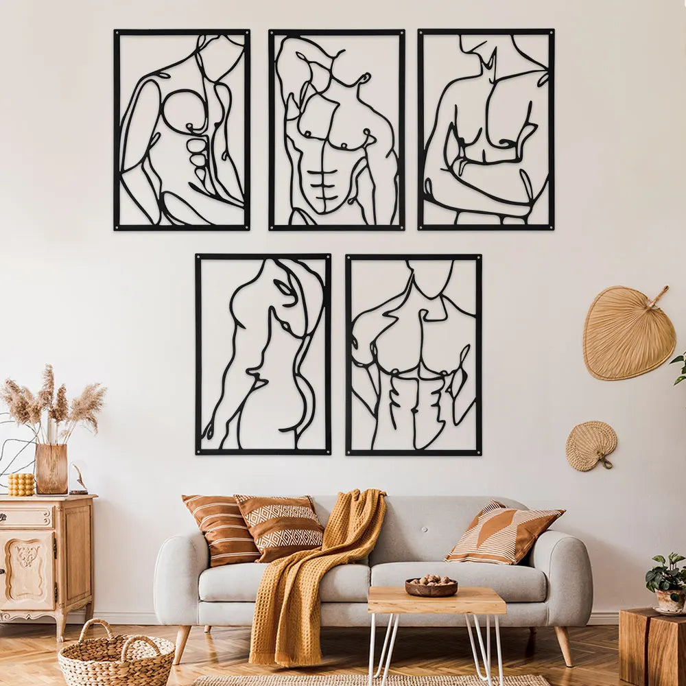 Set of six minimalist black metal line wall art panels arranged above a sofa in a cozy living room