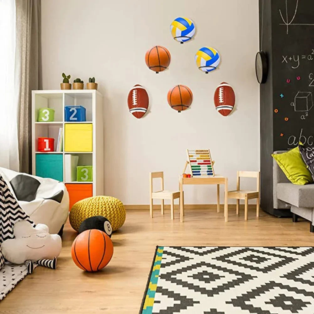 Children's room with multiple wall-mounted ball racks holding basketballs, footballs and volleyballs above a play area