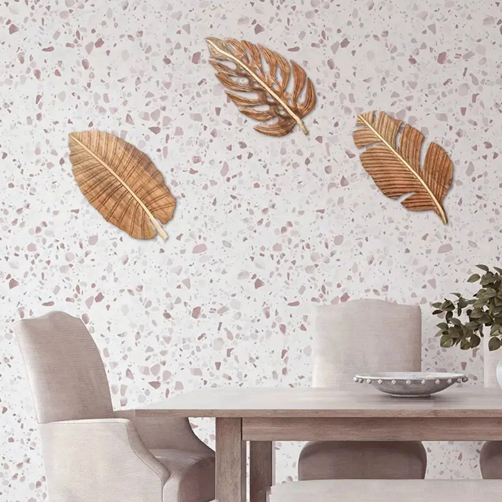Wood leaf wall art set displayed on a terrazzo wall in a light dining room