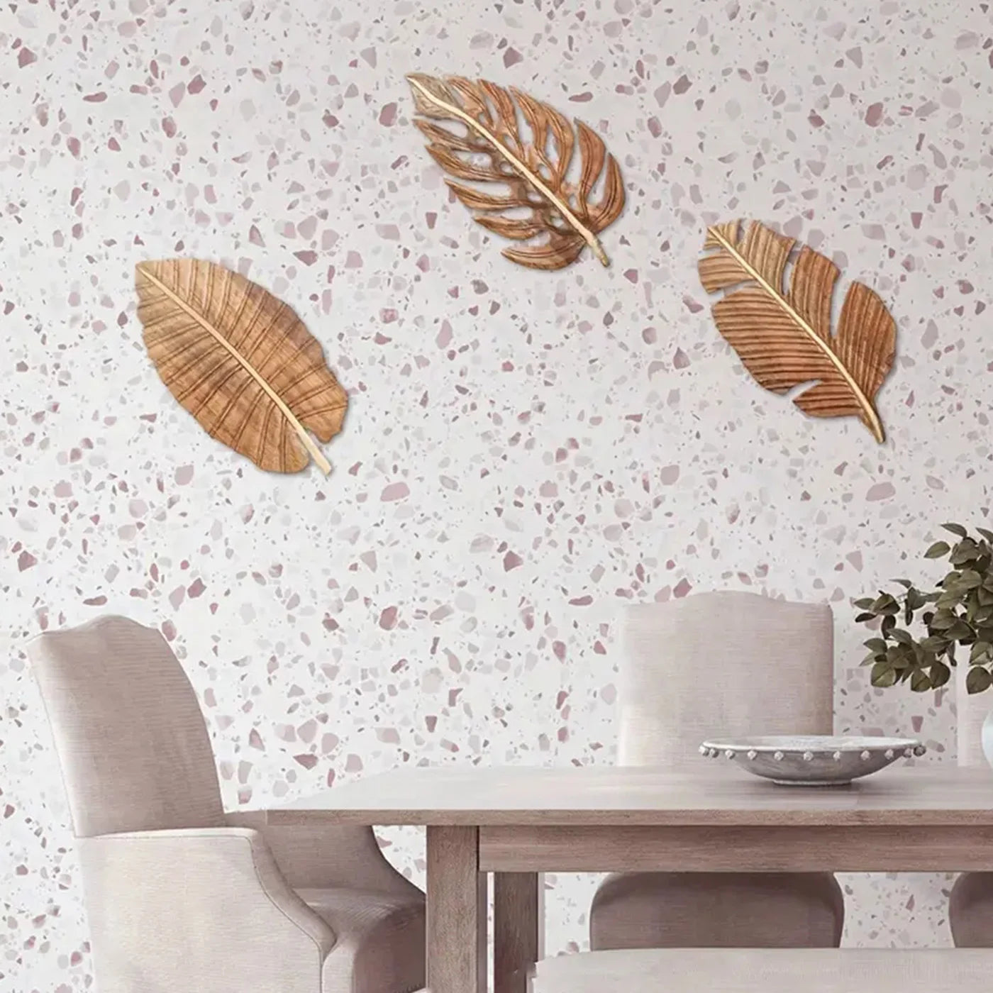 Wood leaf wall art set displayed on a terrazzo wall in a light dining room
