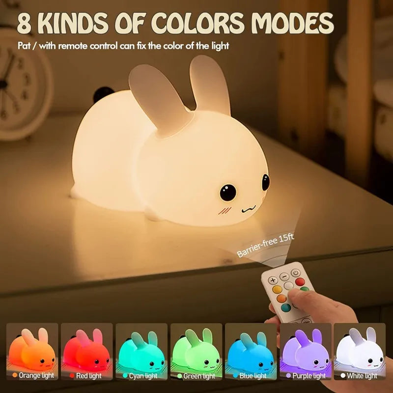 Bunny night light with remote control, showing multiple color modes on a bedside table