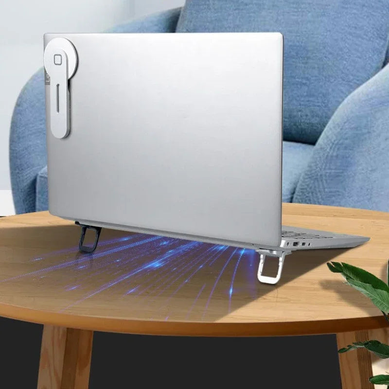 Back view of laptop with mini risers in use on a round wood table, airflow enhancement shown
