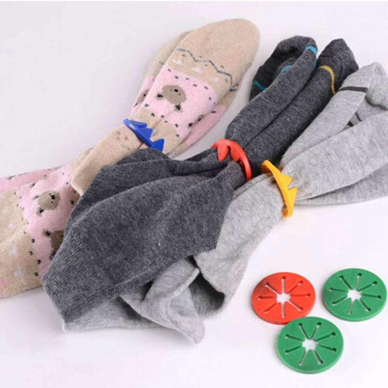 Laundry sock holder clips in use pairing multiple socks, colorful round clips on socks