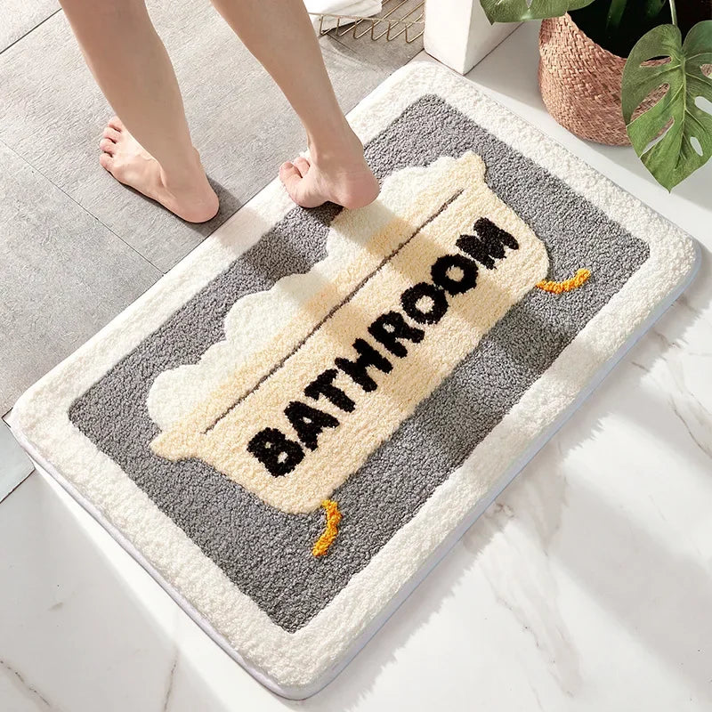 Faux wool bath mat with bathtub motif and gray border, placed on tile flooring in a clean bathroom.