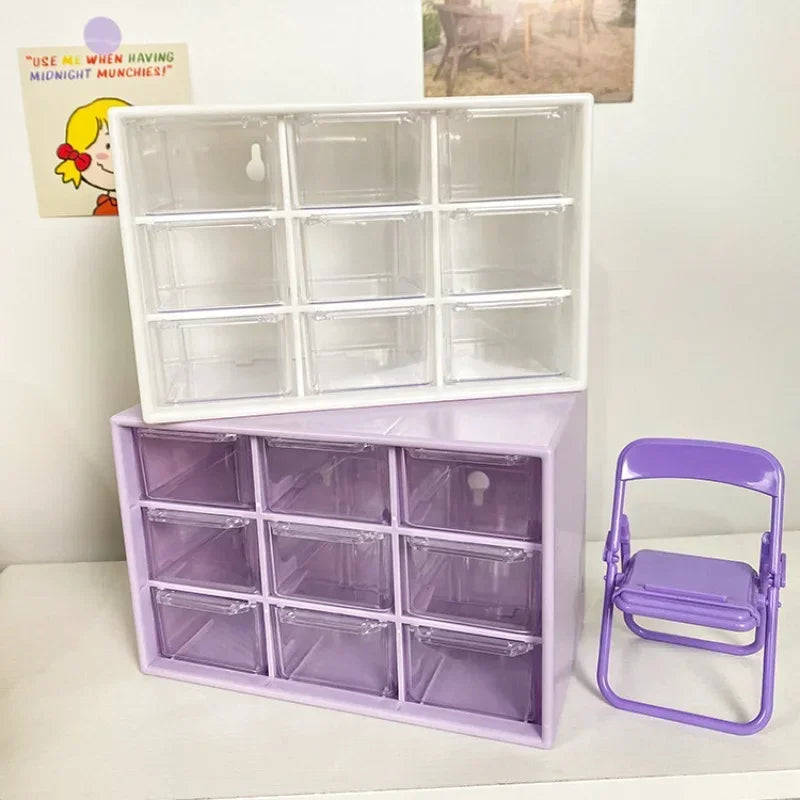 White and purple 9-drawer organizers next to a small purple folding chair on a desk