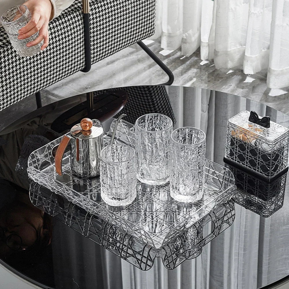 Transparent tray on table used to hold water glasses and a coffee pot