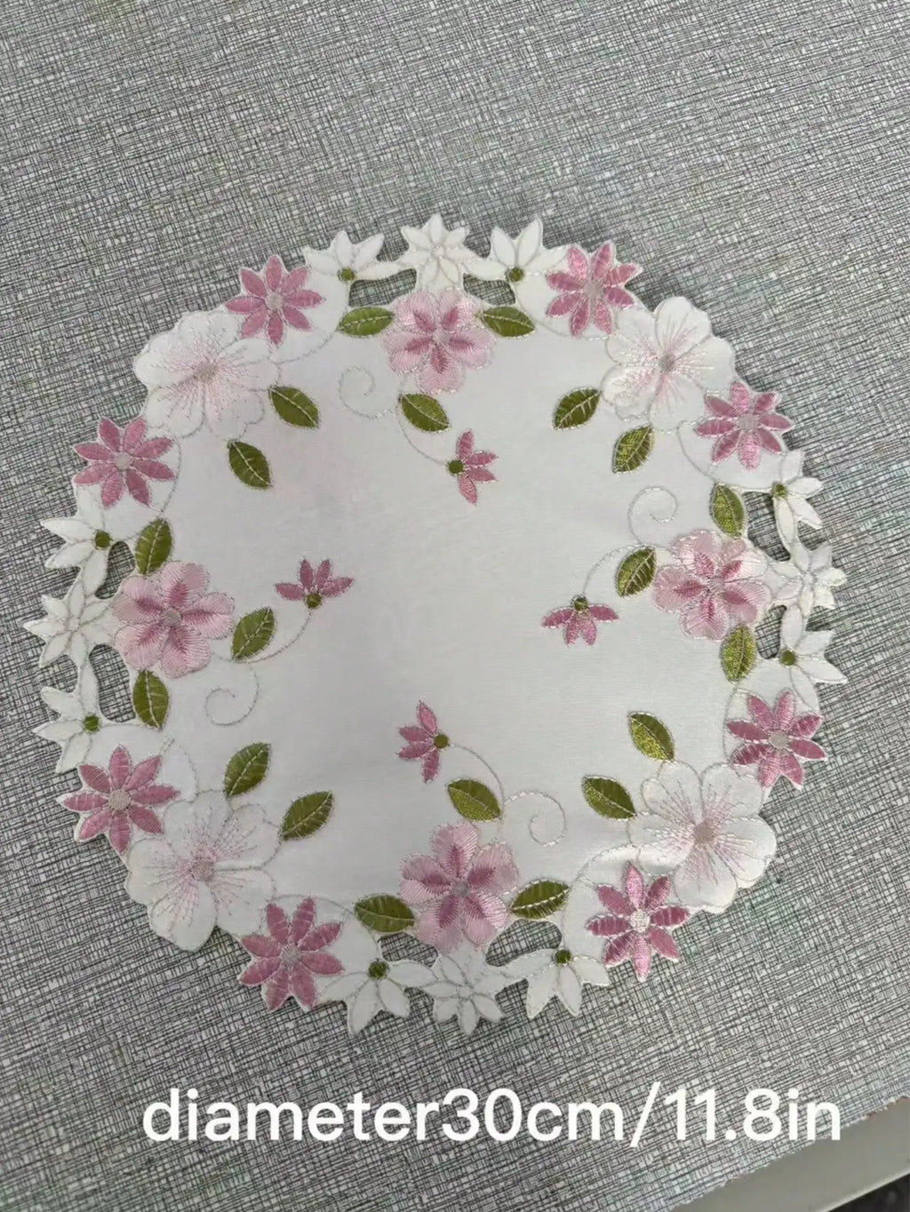 Floral embroidered placemats in oval and rectangle shapes with size information shown, white background with decorative border