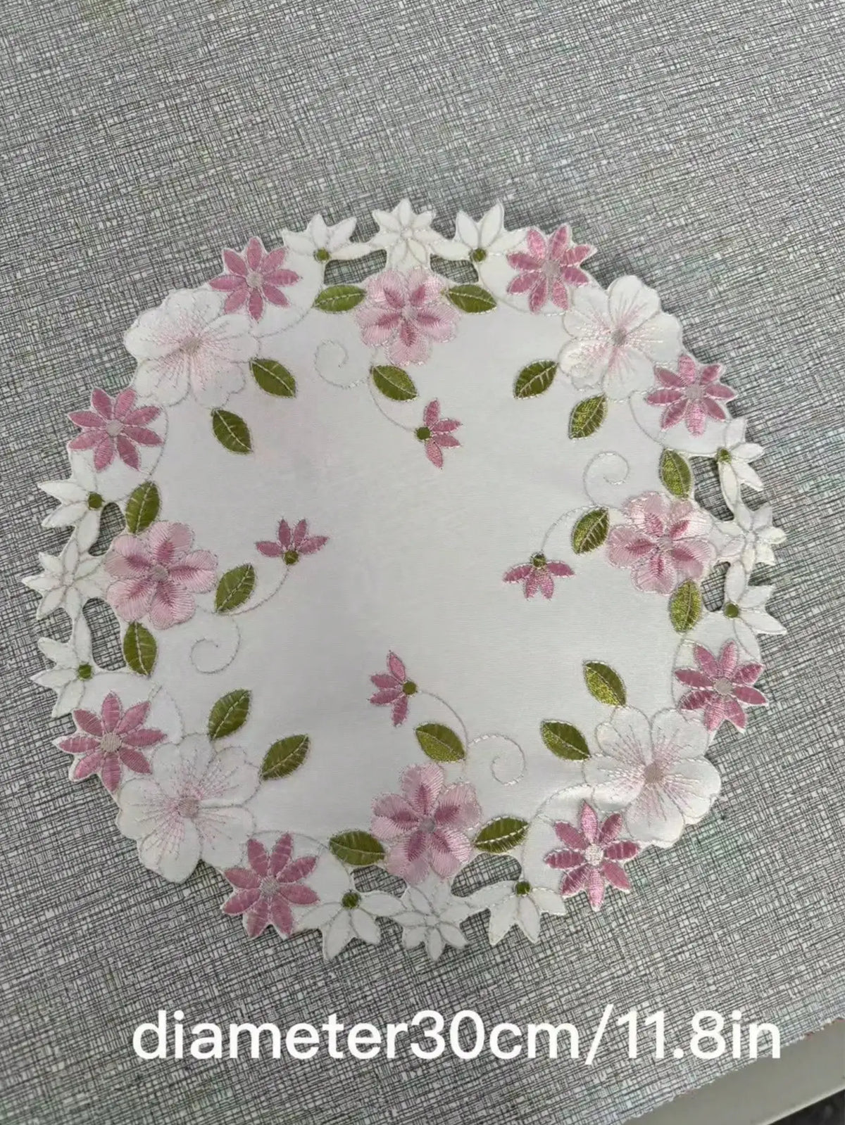 Floral embroidered placemats in oval and rectangle shapes with size information shown, white background with decorative border