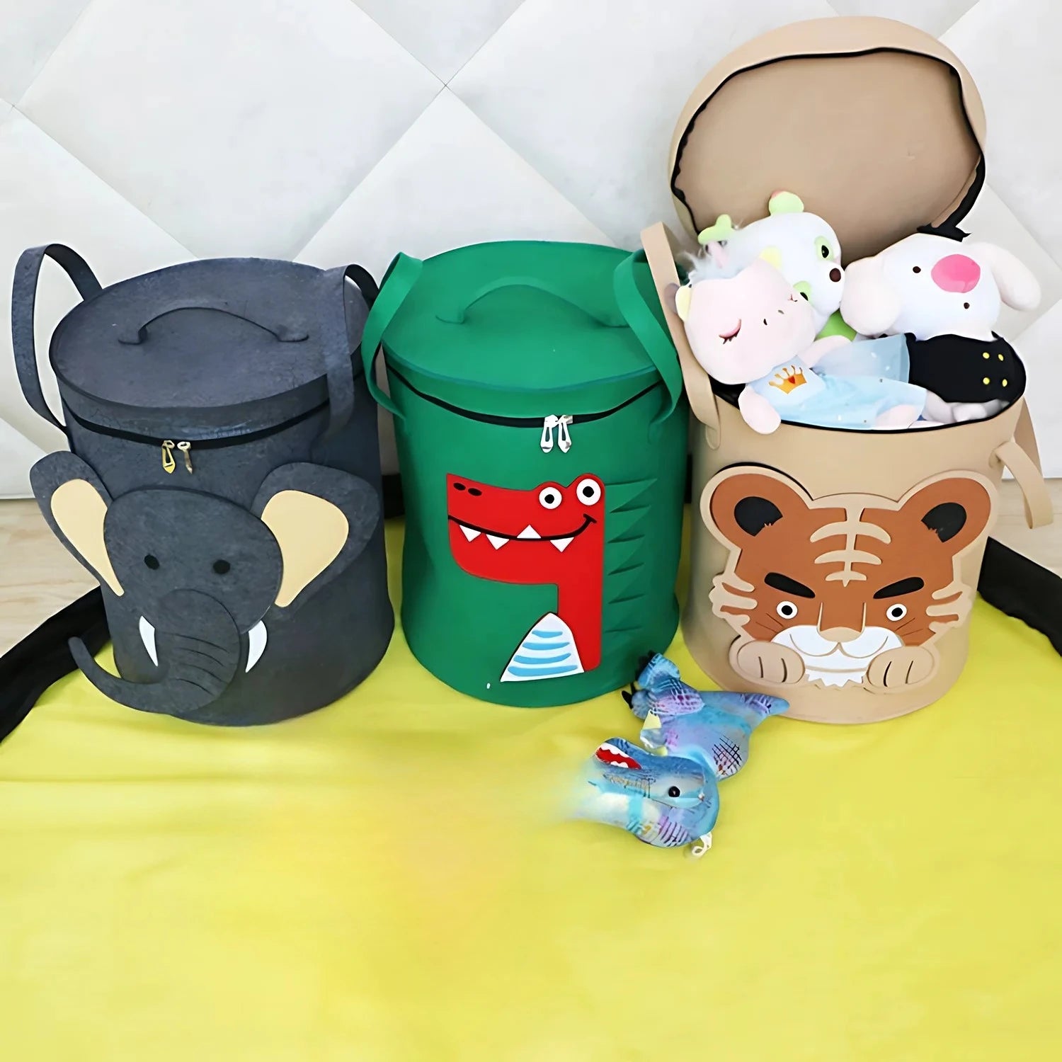 Three animal storage baskets with toys inside, on a play mat in a children's room
