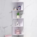 white 5-tier zigzag corner wall shelf mounted on a marble-tiled wall displaying decor and a plant