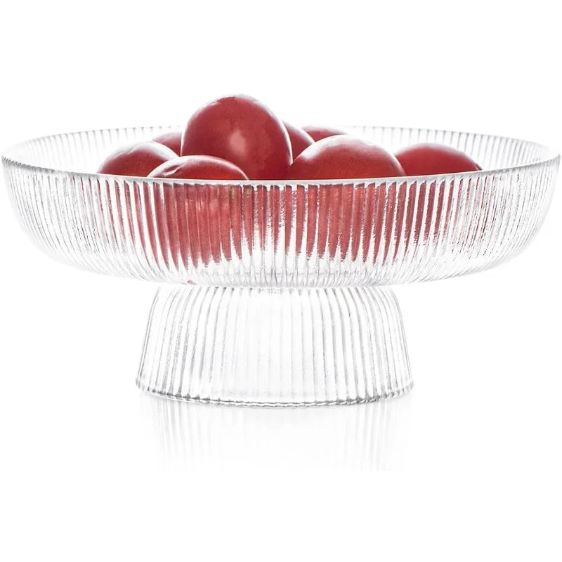 Clear ribbed glass pedestal fruit bowl holding red apples