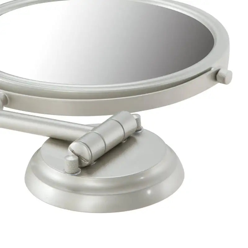 Close-up of the metal hinge and frame of the wall mounted bathroom mirror