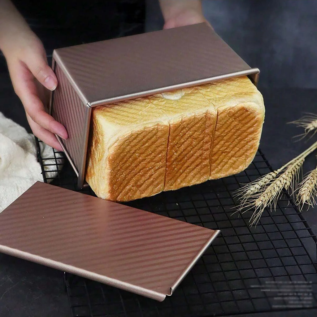 Hands holding golden rectangular bread box with loaf of sandwich bread