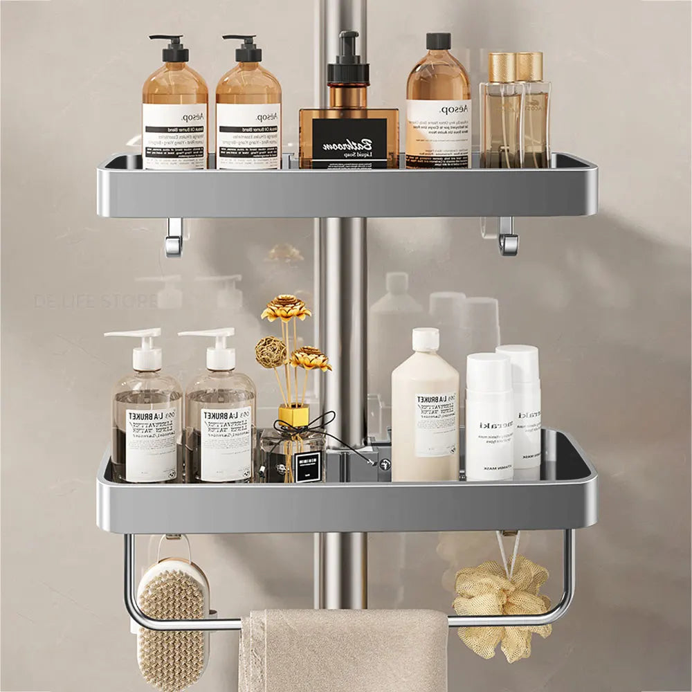 Double gray aluminum shower caddy holding toiletries, attached to a round shower pole with towel bar and hooks visible