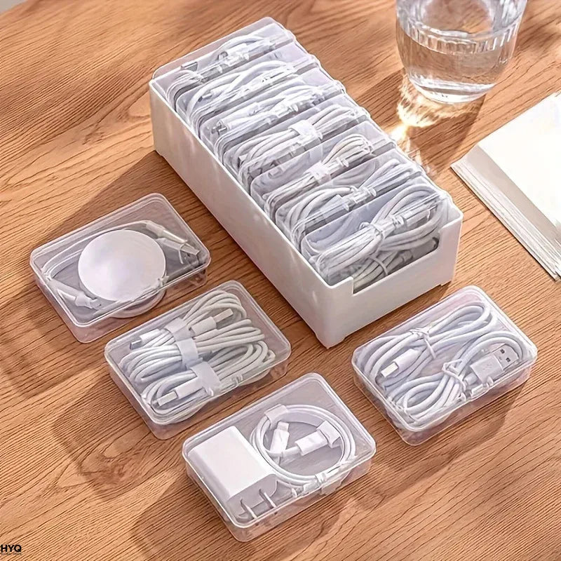Cable organizer box with compartments removed and displayed with various cables and accessories