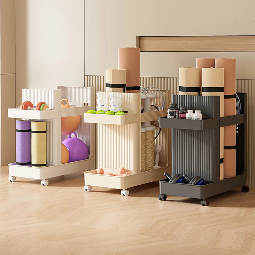 Three rolling equipment carts in a home interior setting, each organized with yoga mats, balls, and fitness gear