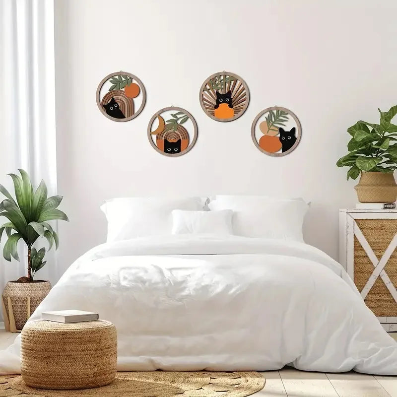 Boho cat wooden wall art set arranged on a light bedroom wall above a white bed in a cozy, airy space
