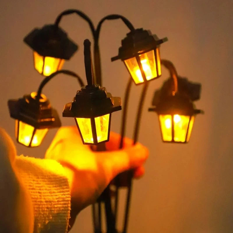 Hand holding outdoor solar lantern light with warm yellow glow