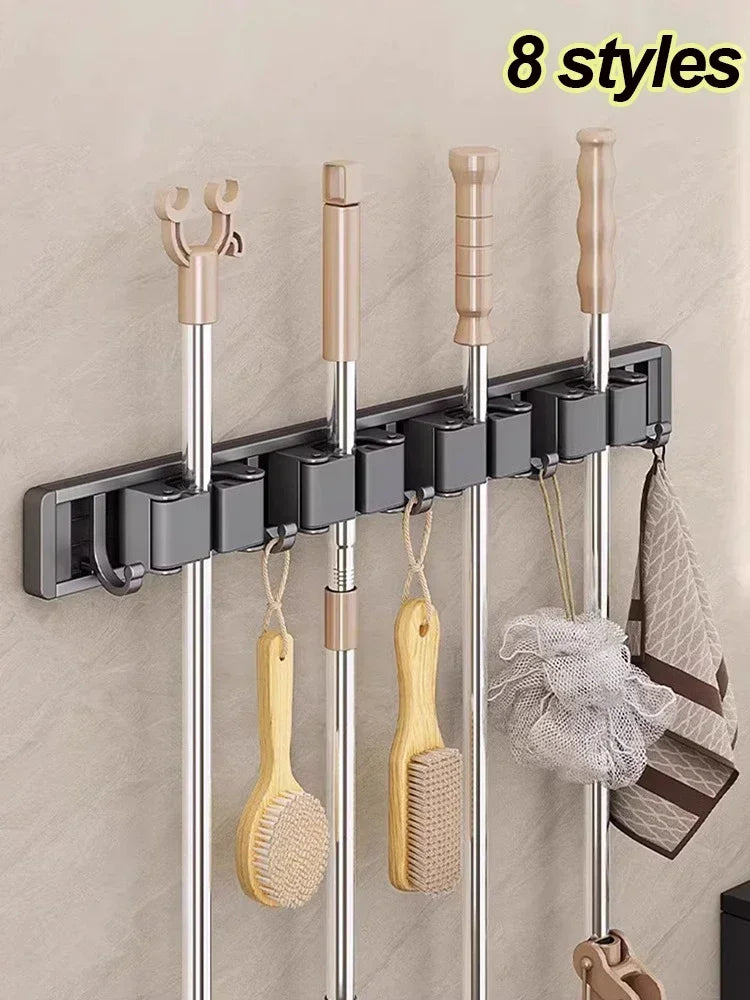 Wall-mounted broom and mop holder with hooks in use on a smooth wall, organizing tools and accessories