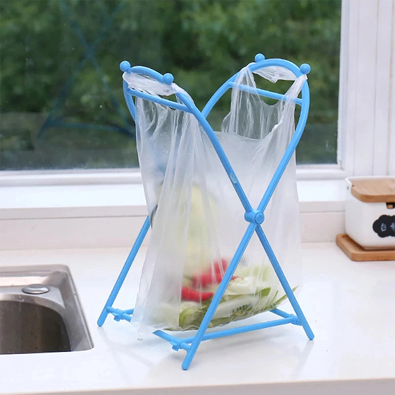 Blue foldable trash bag holder stand with open bag on kitchen counter