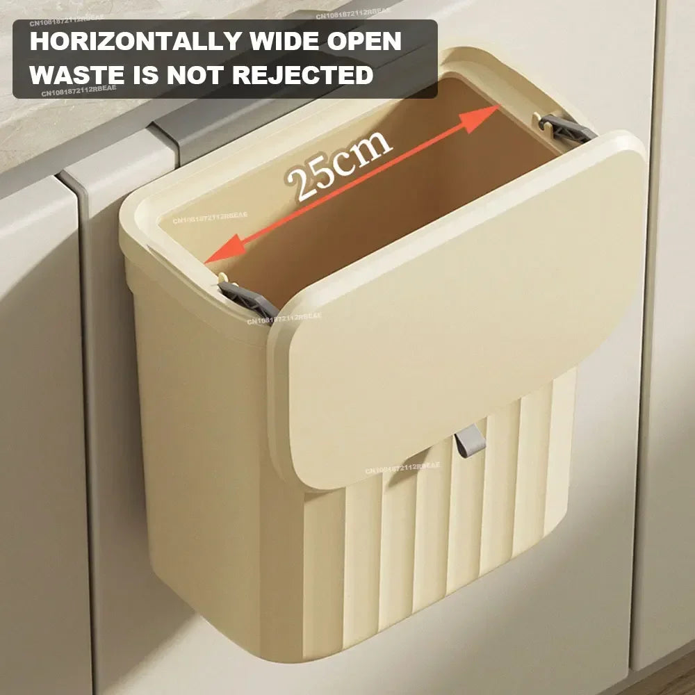 Beige wall-mounted trash bin with open bi-directional lid and horizontal width measurement shown