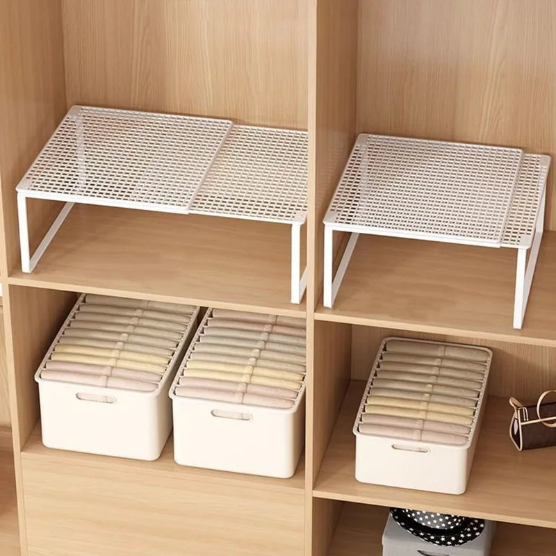 Pair of white adjustable steel shelf dividers side by side on upper shelves with bins below in a wooden wardrobe
