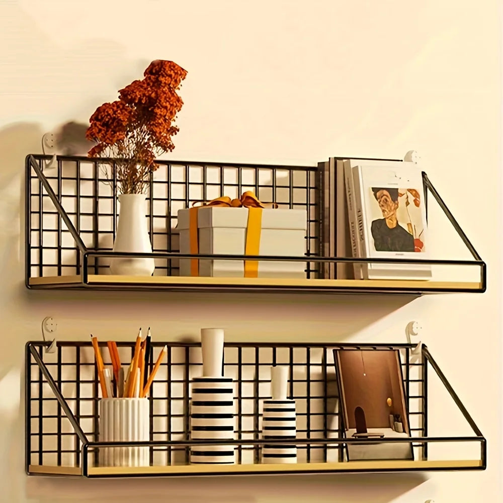 Two wood and black metal floating wall shelves styled with books, vases, and a gift box