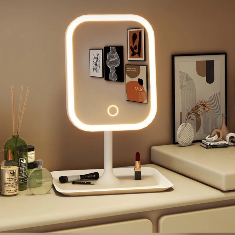 LED desktop makeup mirror on a vanity with tray for cosmetics, lit with warm light