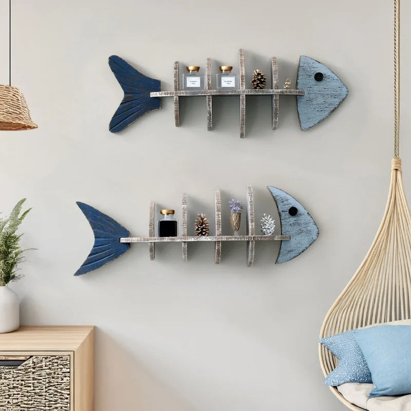 Two fishbone wall shelves shown with pinecones, candles, and decor in a cozy room