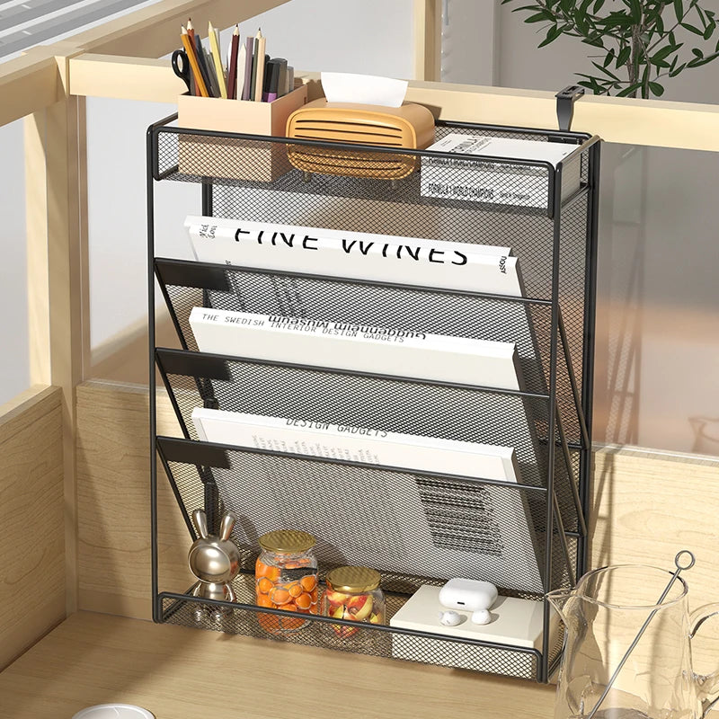 Black mesh wall-mounted desk organizer with adjustable hooks holding documents and small items in a home office setting