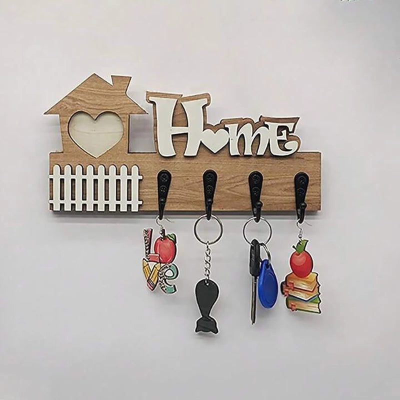 wooden key holder wall hook with home motif and keys hanging from 4 hooks