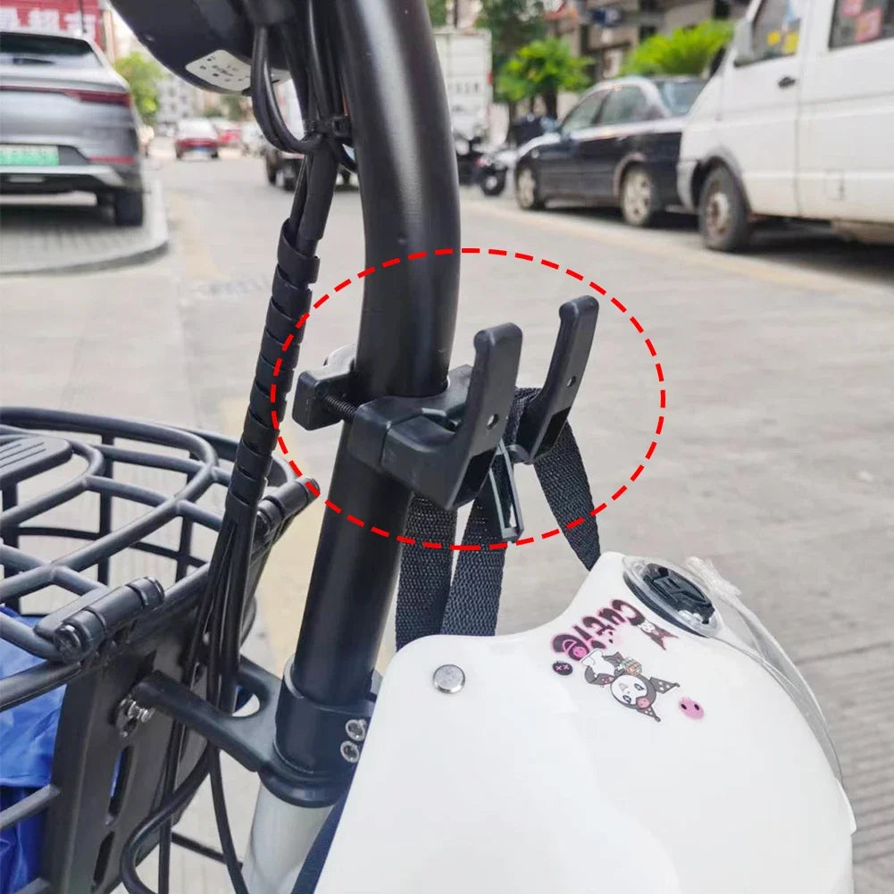 Double hook mounted to electric bike with a helmet strap hanging from it.