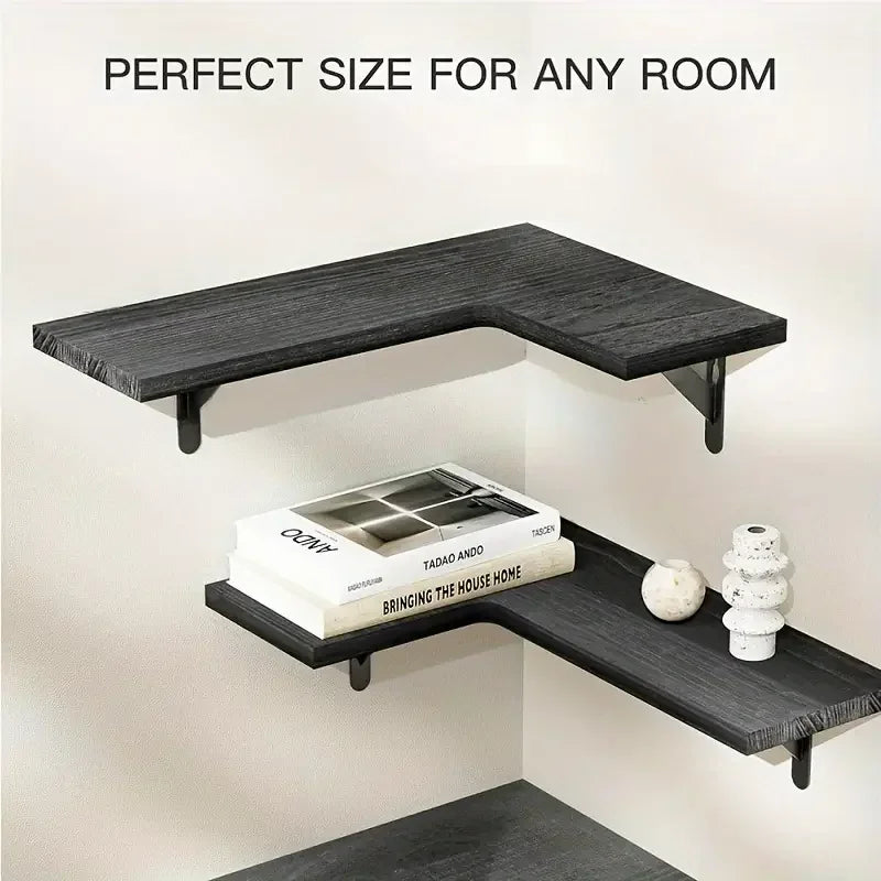 Two black L-shaped wood corner wall shelves mounted on a white wall, styled with books and minimal decor