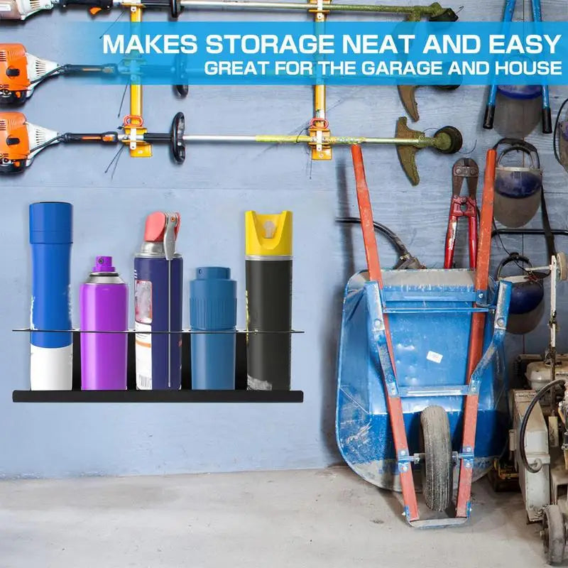 Spray can organizer mounted on a garage wall with assorted tools and equipment in the background